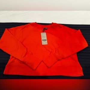 SWEATY BETTY CROPED LIGHT WAIGHT TOP IN ORNAGE SIZE SMALL, NEW WITH TAGS
